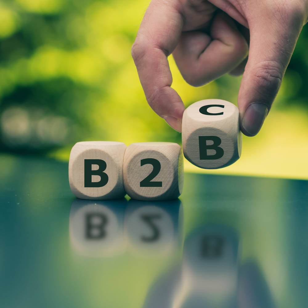 Business to Business or Busness to Consumer? Hand turns a dice and changes the expression "B2B" to "B2C" (or vice versa)